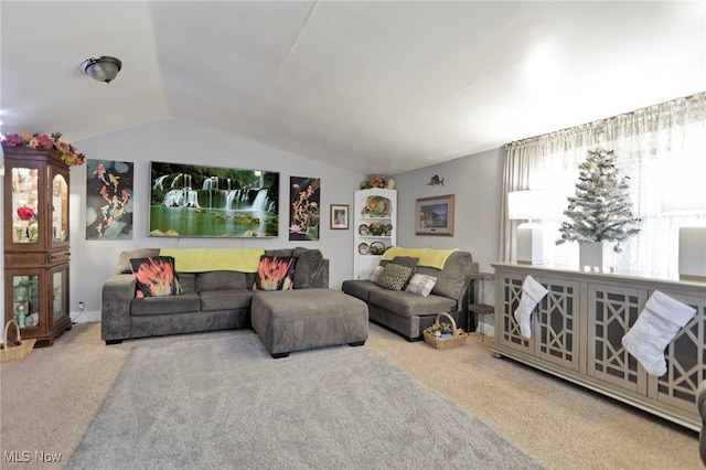 living room featuring carpet flooring and vaulted ceiling