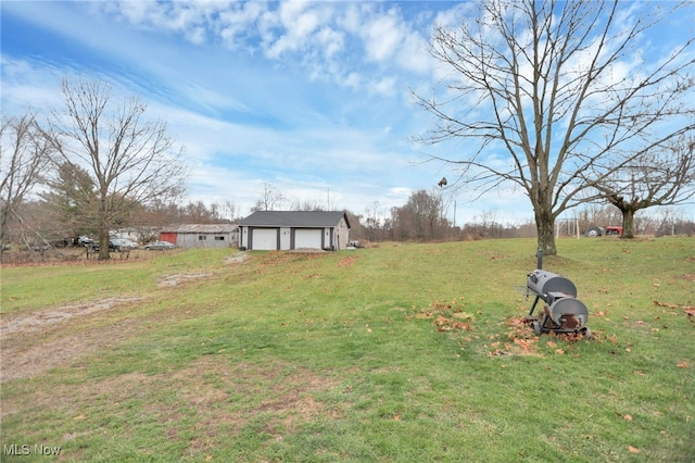 view of yard with a garage and an outdoor structure