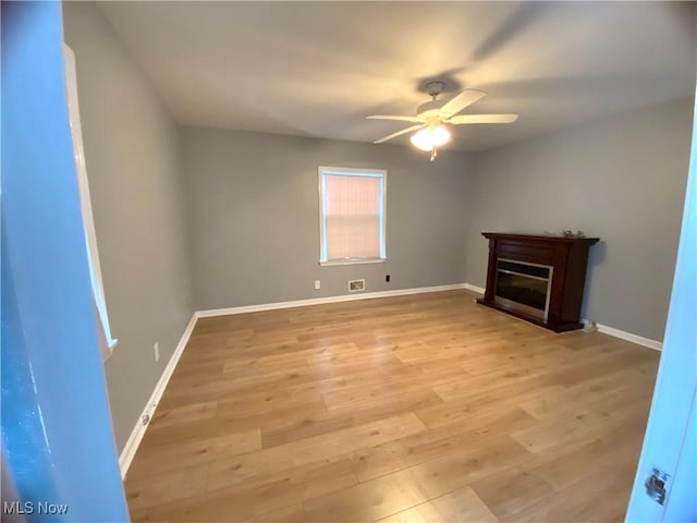 unfurnished living room with ceiling fan and light hardwood / wood-style floors