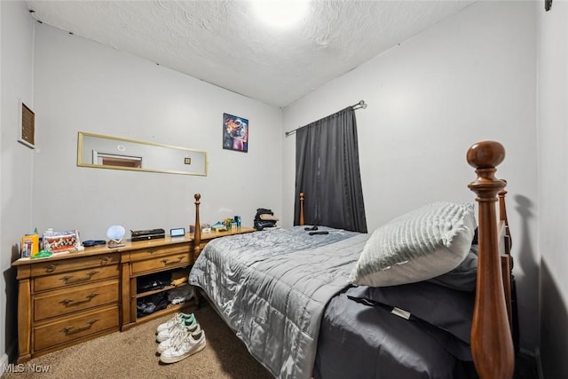 bedroom featuring carpet floors and a textured ceiling