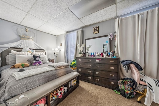 carpeted bedroom with a paneled ceiling