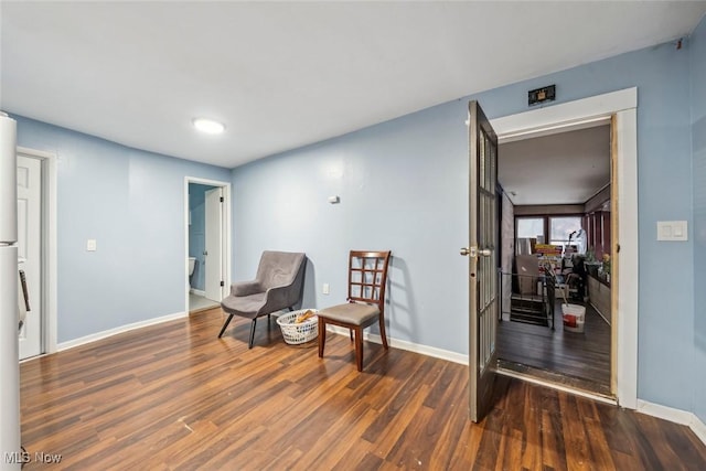 sitting room featuring dark wood-type flooring