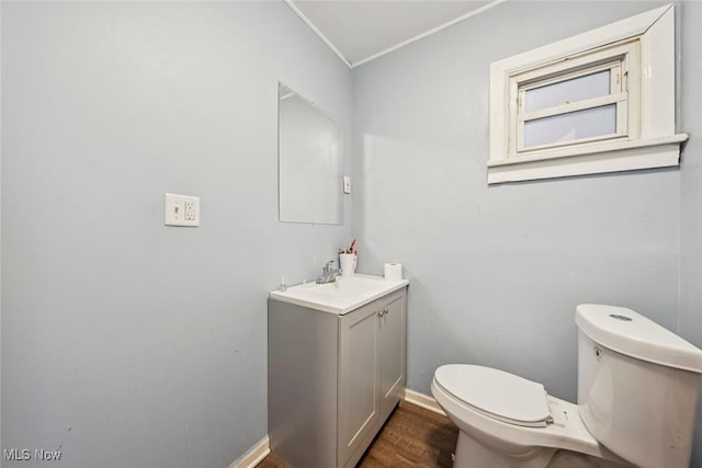 bathroom featuring wood-type flooring, vanity, and toilet