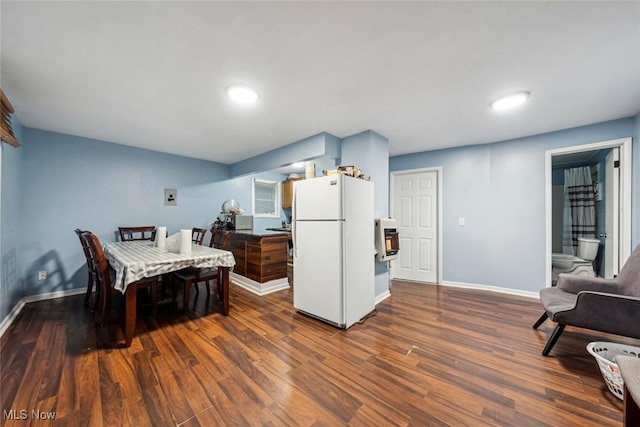 kitchen featuring white refrigerator and dark wood-type flooring