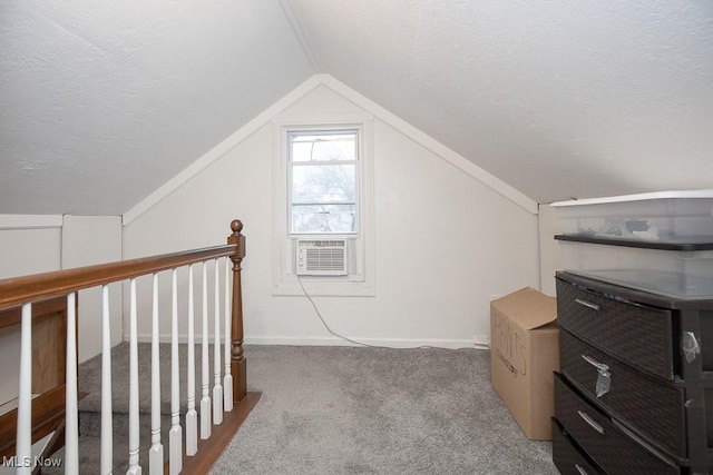 additional living space with a textured ceiling, light colored carpet, cooling unit, and lofted ceiling