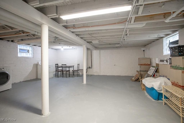 basement featuring washer / dryer and a healthy amount of sunlight