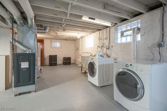 laundry area with washer and clothes dryer, sink, and water heater