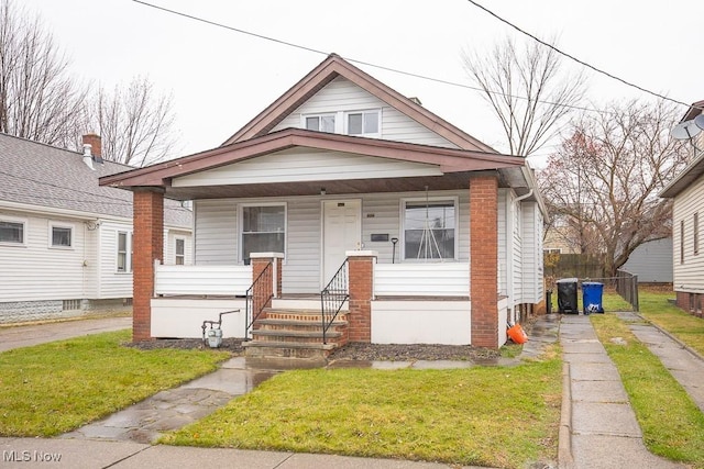 bungalow-style house featuring a porch and a front lawn