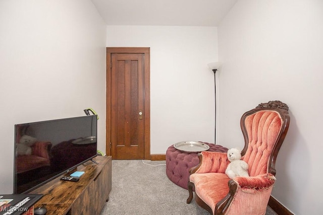 sitting room featuring light colored carpet