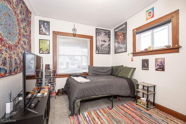 bedroom with carpet floors and multiple windows