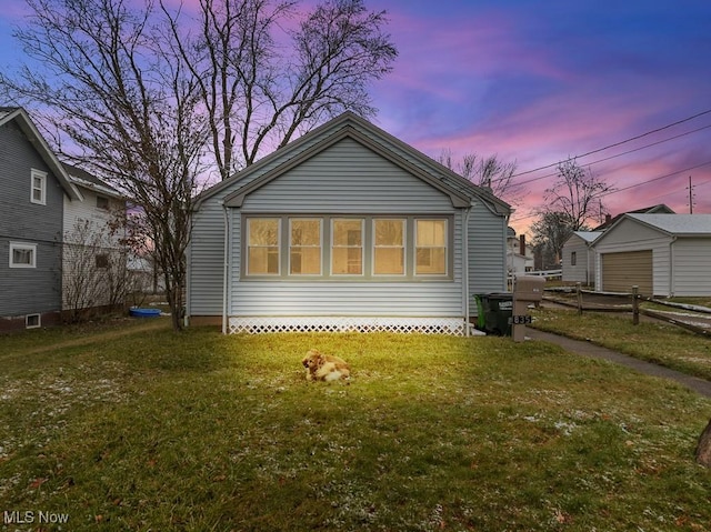 back house at dusk with a yard