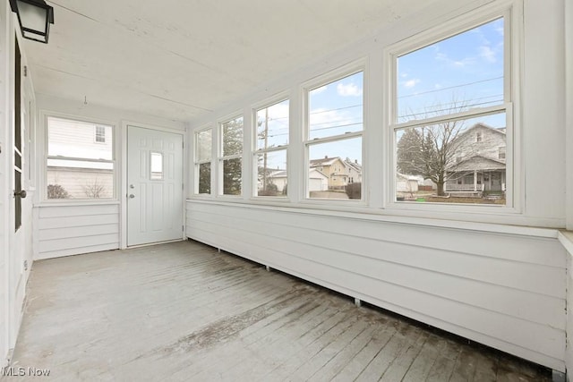 unfurnished sunroom with plenty of natural light