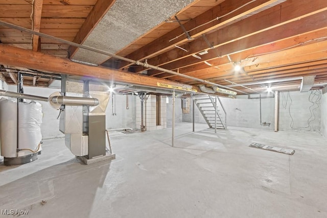 basement with electric panel and water heater