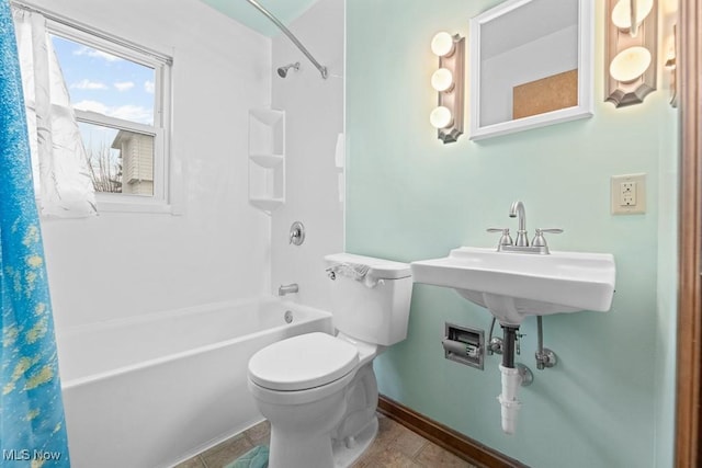 bathroom with shower / bath combination with curtain and toilet