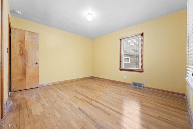 unfurnished room with light hardwood / wood-style flooring