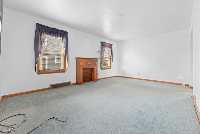 carpeted spare room with a healthy amount of sunlight