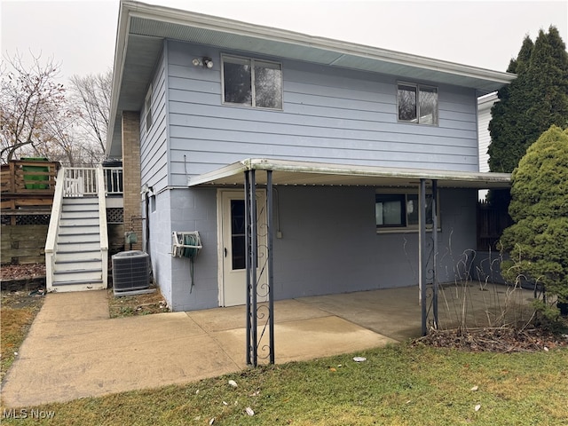 rear view of property featuring cooling unit and a patio area