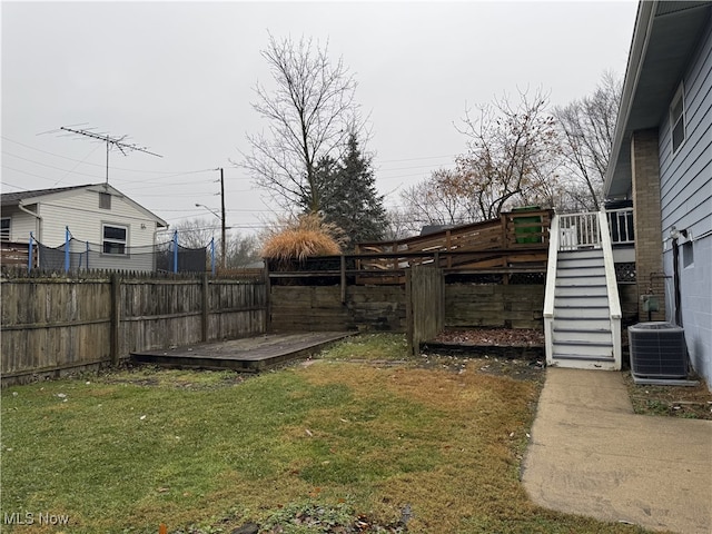 view of yard featuring central air condition unit and a deck