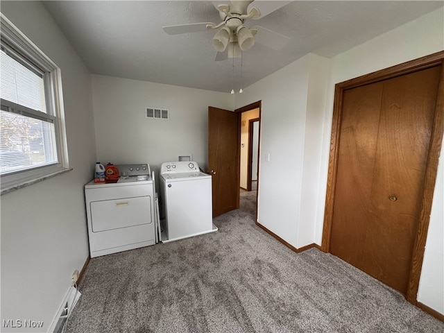 laundry room with washer and dryer, light colored carpet, and ceiling fan