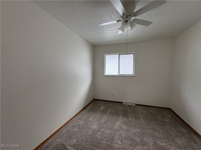 carpeted empty room with a textured ceiling and ceiling fan