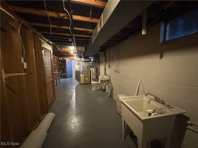 basement featuring heating unit and sink