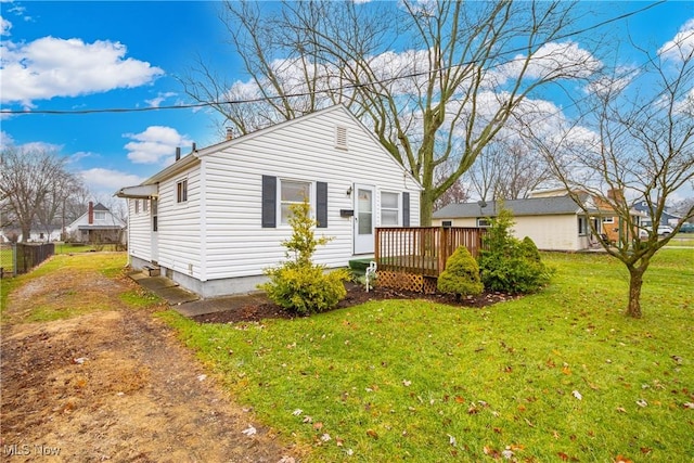 view of front of property with a front lawn and a wooden deck