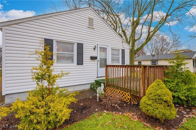 rear view of house featuring a deck