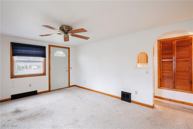 unfurnished room featuring ceiling fan and light colored carpet