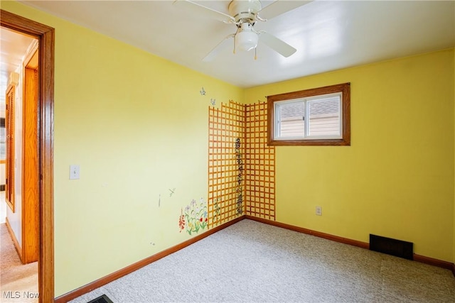 unfurnished room with ceiling fan and light carpet