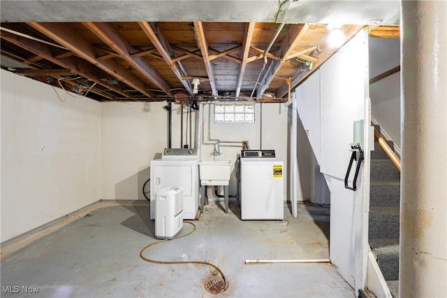 basement with separate washer and dryer and sink