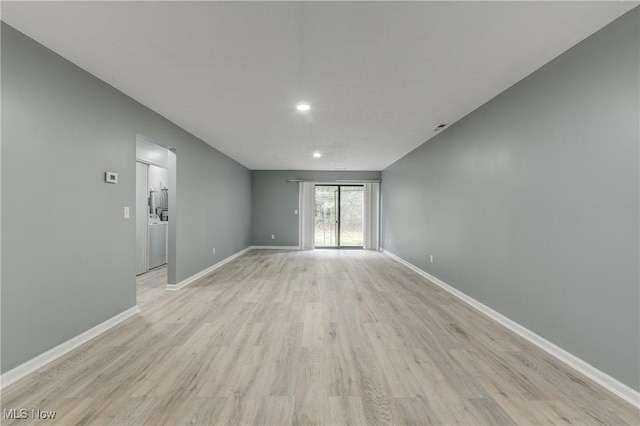 empty room with light hardwood / wood-style flooring