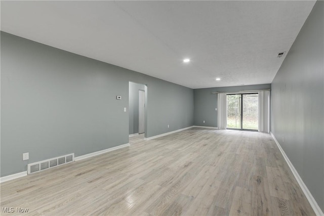 spare room with light wood-type flooring