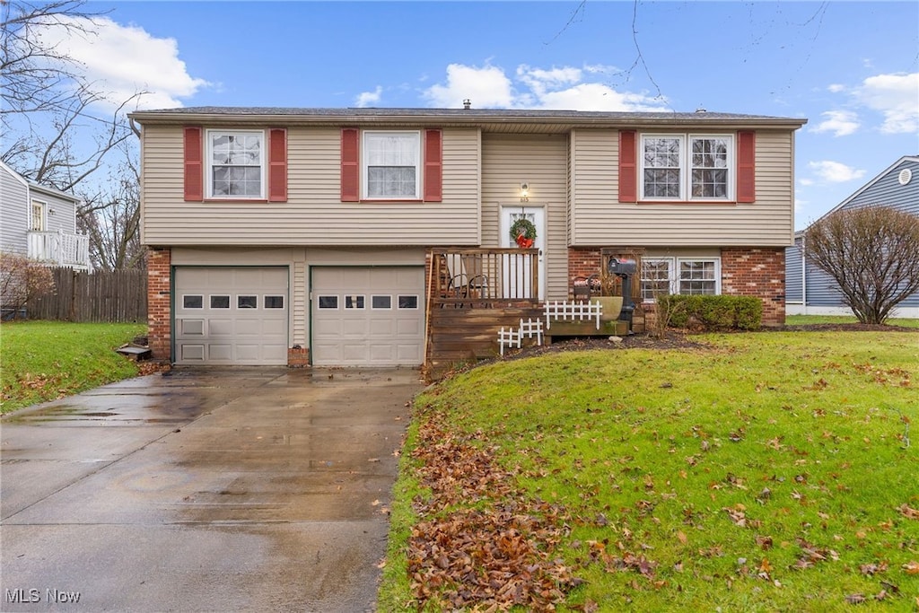 bi-level home featuring a front yard and a garage