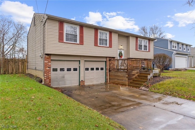 bi-level home featuring a wooden deck, a front lawn, and a garage