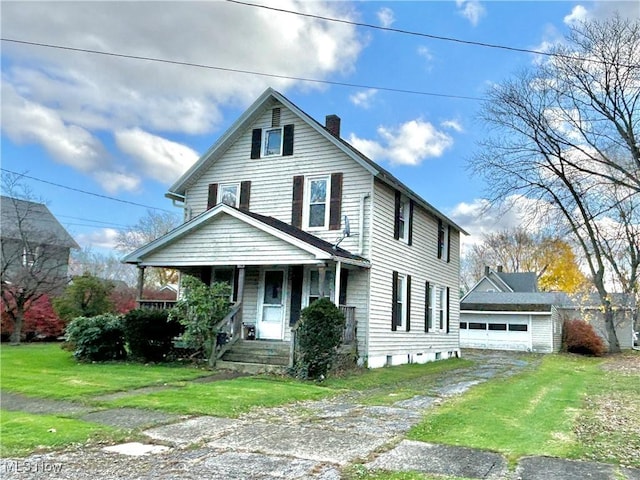 view of front of house with a front lawn, covered porch, an outdoor structure, and a garage