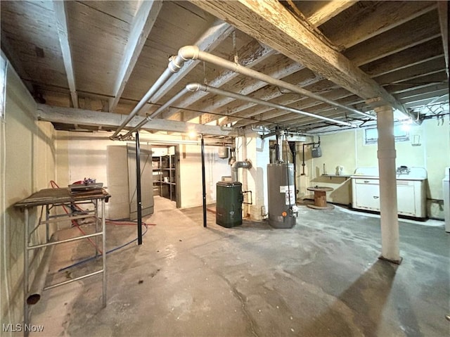 basement with washing machine and clothes dryer and gas water heater