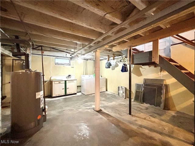 basement with water heater and washer and clothes dryer