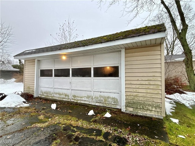 exterior space with a garage and an outdoor structure