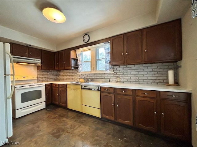 kitchen featuring dark brown cabinets, white appliances, sink, and tasteful backsplash