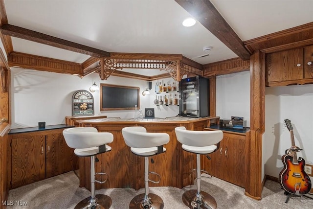 bar featuring beam ceiling and light carpet