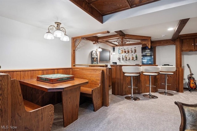 bar with wooden walls and carpet floors