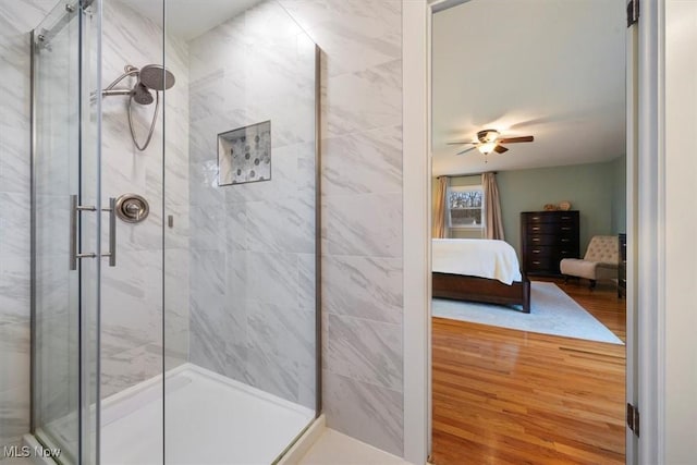 bathroom featuring an enclosed shower and wood-type flooring