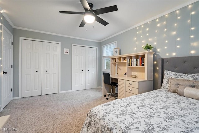 carpeted bedroom with multiple closets, ceiling fan, and ornamental molding