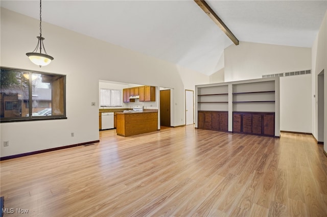 unfurnished living room featuring light hardwood / wood-style floors, beam ceiling, and high vaulted ceiling