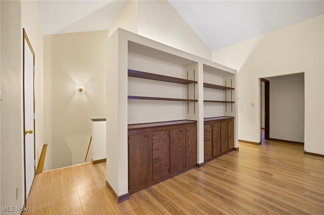 interior space with light hardwood / wood-style flooring and lofted ceiling