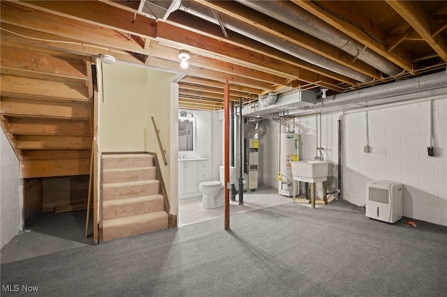 basement with water heater and sink