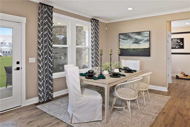 dining area featuring crown molding and hardwood / wood-style floors