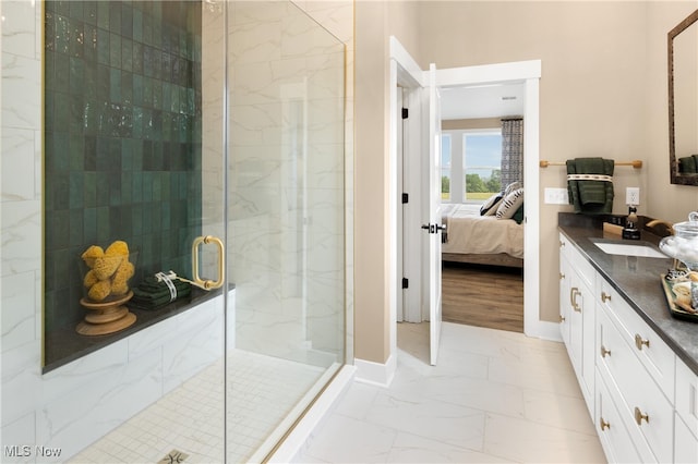 bathroom with a shower with door and vanity