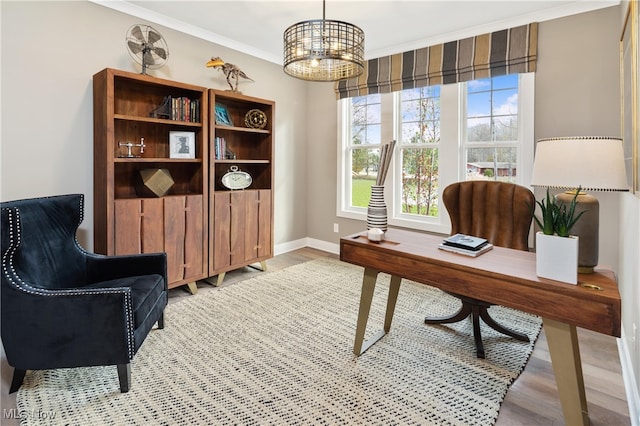 office space with light hardwood / wood-style floors, ornamental molding, and a notable chandelier