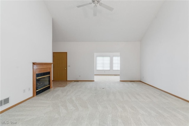 unfurnished living room featuring light carpet, ceiling fan, and lofted ceiling